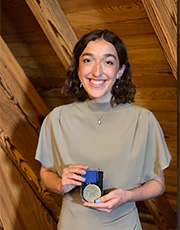 Grace Wallis holds her medal.