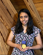 Shirley Syed holds her medal.