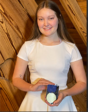 Sylvia Young holds her medal at the award ceremony.