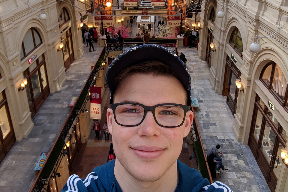 Jake Bernstein A selfie of Jake Bernstein taken from above a busy shopping area.