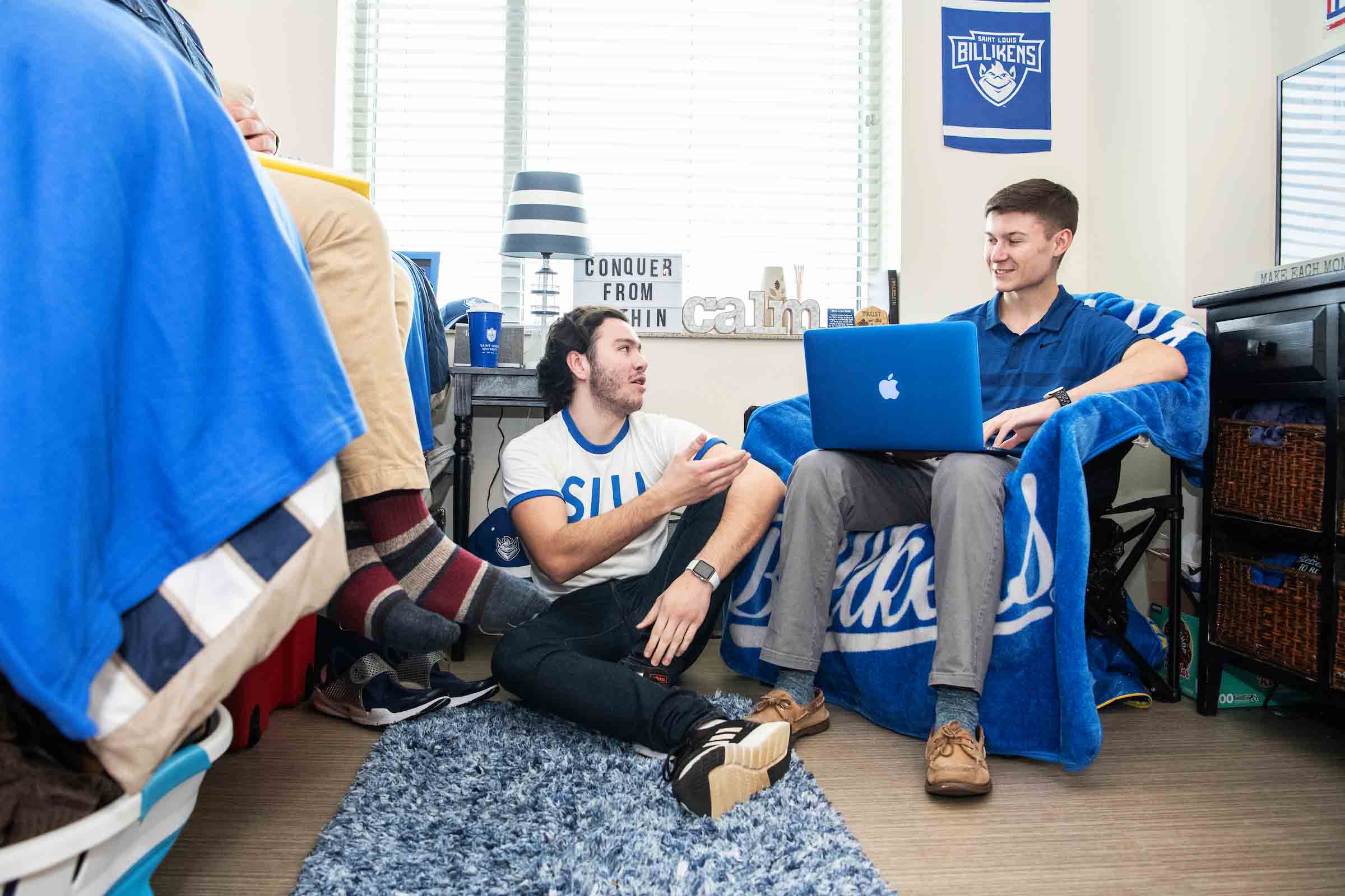 Two college roommates sitting on floor in residence hall