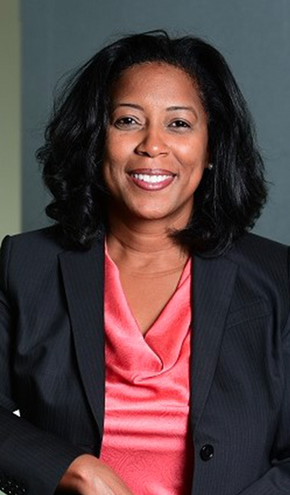 Toschia Hogan, Ph.D., smiles for a headshot photo wearing a black blazer          