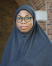 Bilqees Odewale poses for a photo outside of Cook Hall