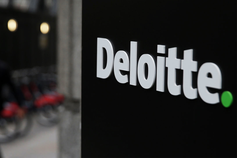 Deloitte logo on an office wall. 