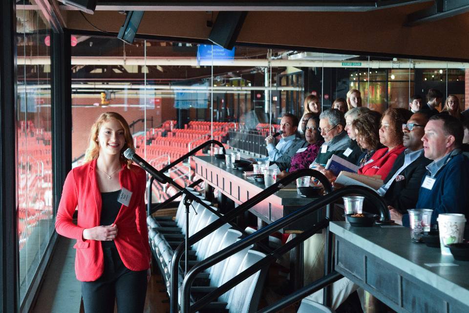 An entrpreneurship students pitches her business in the press box of Busch Stadium to a panel of judges at a Chaifetz Center for Entrepreneurship pitch contest, 