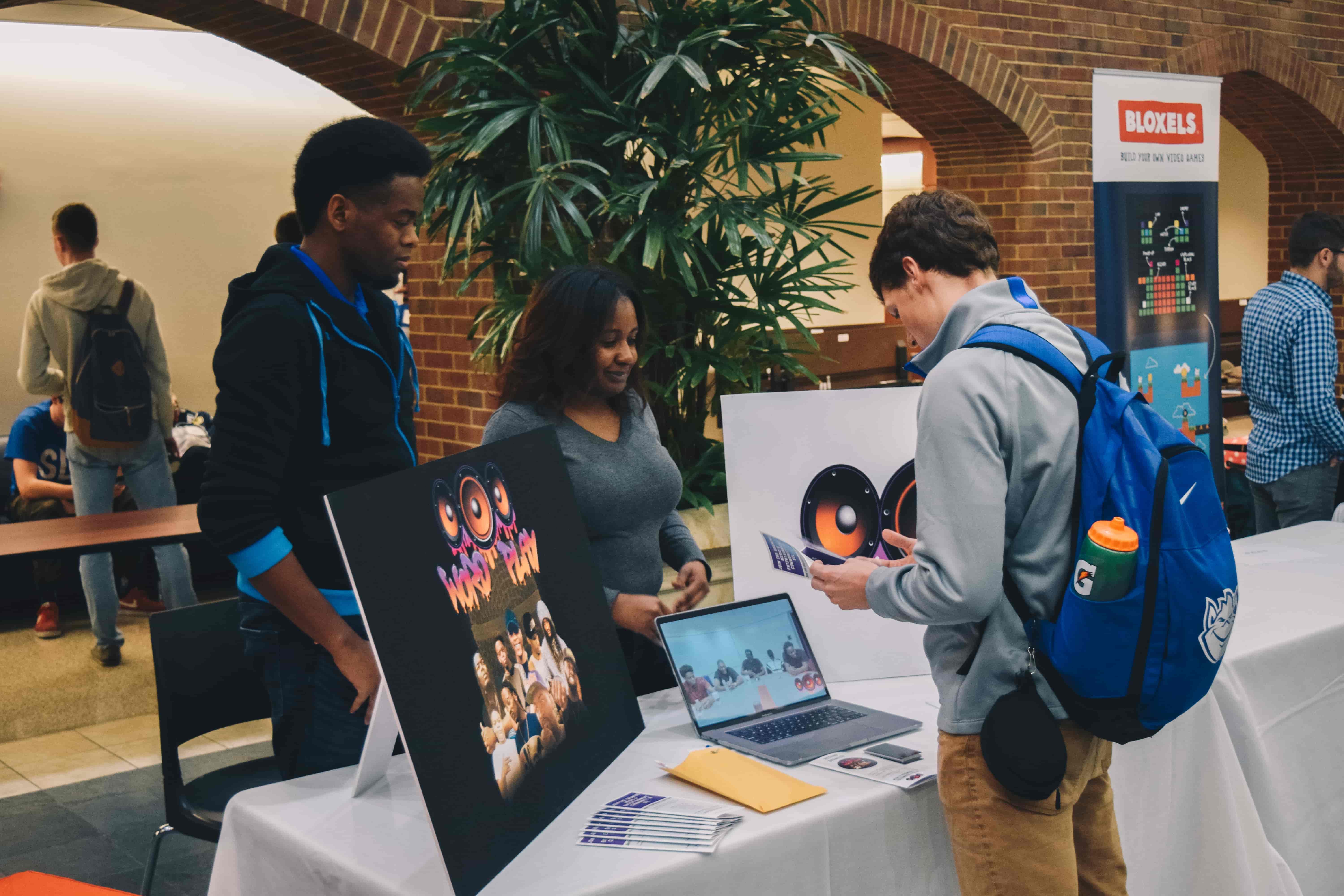 student talking with business at billicon valley