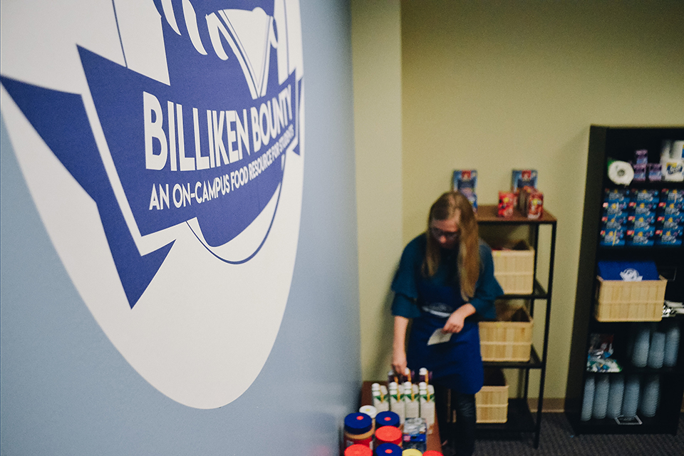 Business Student Stock Shelves in Student Food Pantry