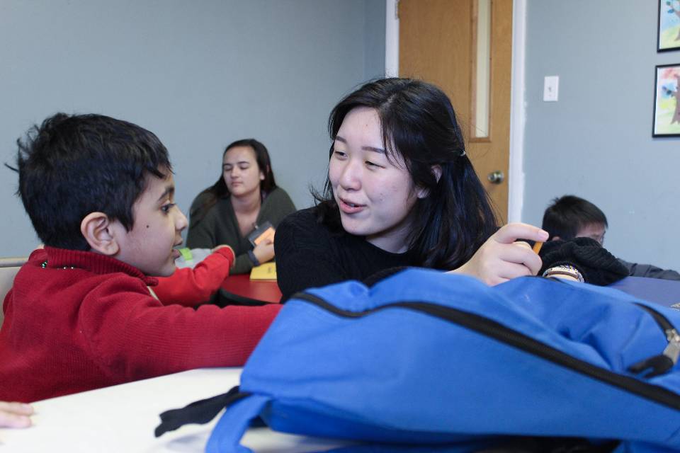 Servant Leader Soi Lee tutors a student at Firm Foundation South