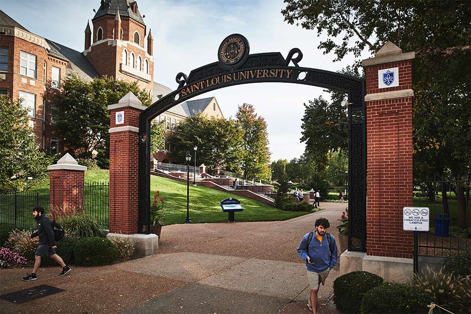 An entrance to SLU with Cook Hall visible in the background.
