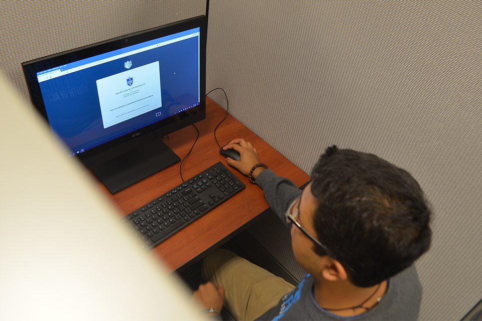 A student in the behavioral lab at Saint Louis University's Chaifetz School of Business completes a consumer percpetion survey as part of faulty research project.