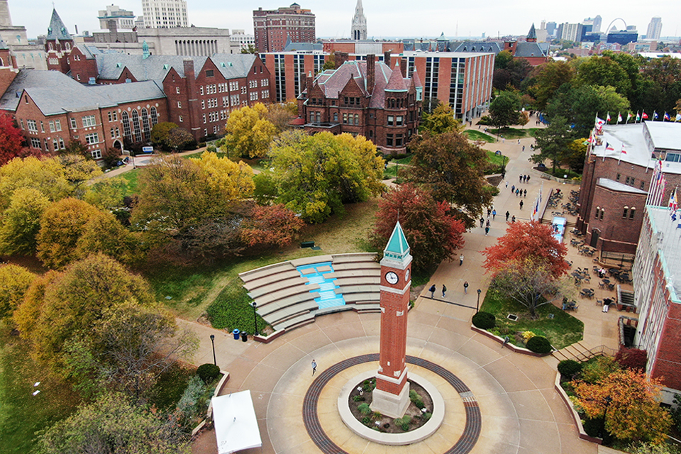 Aerial photo of the clocktower on the campus of Saint Louis University with the Cahifetz School of Business in the background.