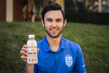 Luis Manta holds a bottle of his product, Seoul Juice, which he created while playing soccer at Saint Louis University.