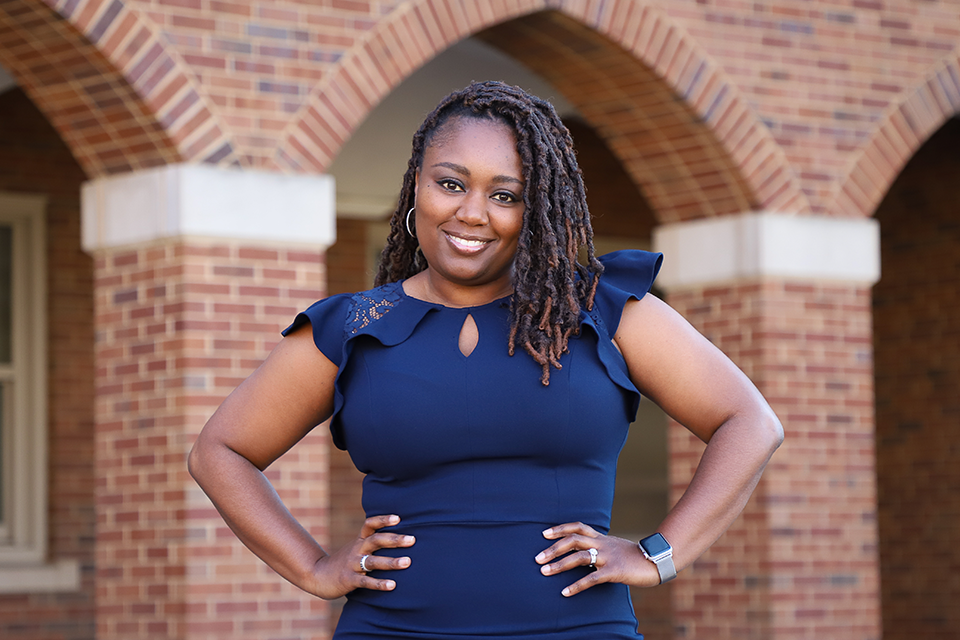 Tamika Mitchell, Chaifetz School Expert in Residence for Diversity, Equity and Inclusion, poses for photo outside Cook Hall on the campus of Saint Louis University. 