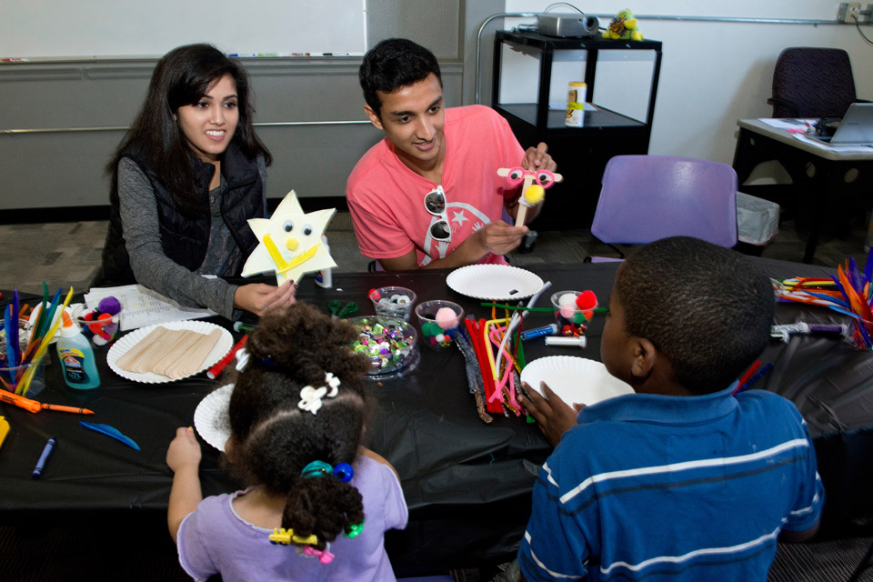 Students crafting with children