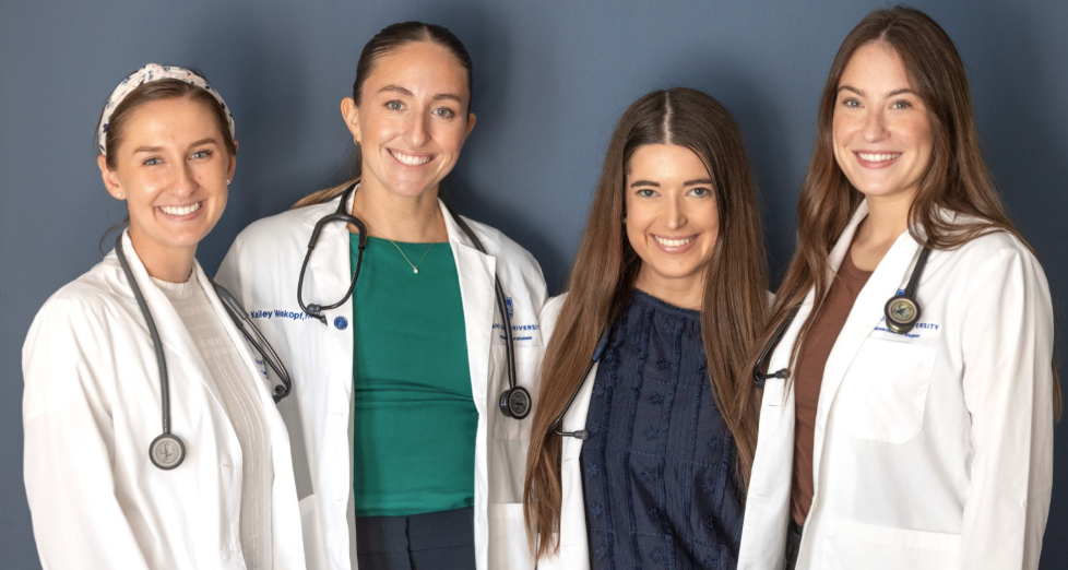A group of four SLU PA students pose and smile