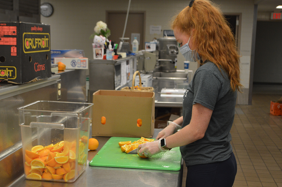Student prepping food for the School Lunch Program