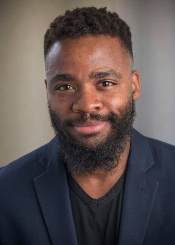 Darnell Leatherwood, Ph.D., wearing a black blazer, smiles at the camera in his headshot.