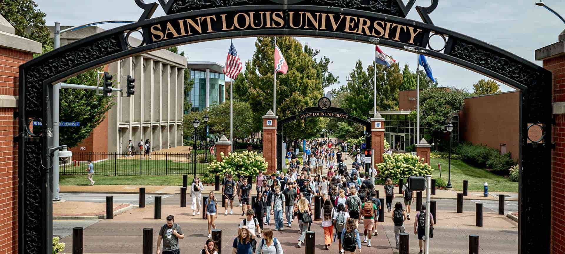 Two students walk down steps in front of Pius XII Memorial Library