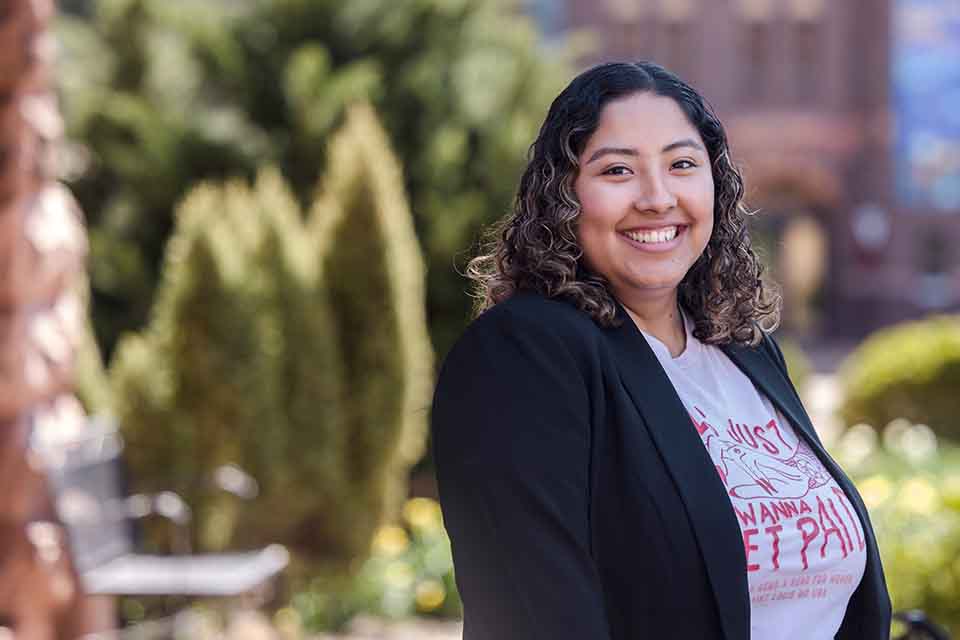 A headshot of Alicia Avellaneda-Cruz standing outside on SLU's campus