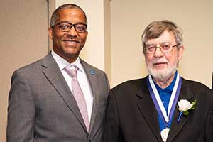 A headshot of SLU donor Frank Magiera, Ph.D., and dean Gregory Triplett, Ph.D.