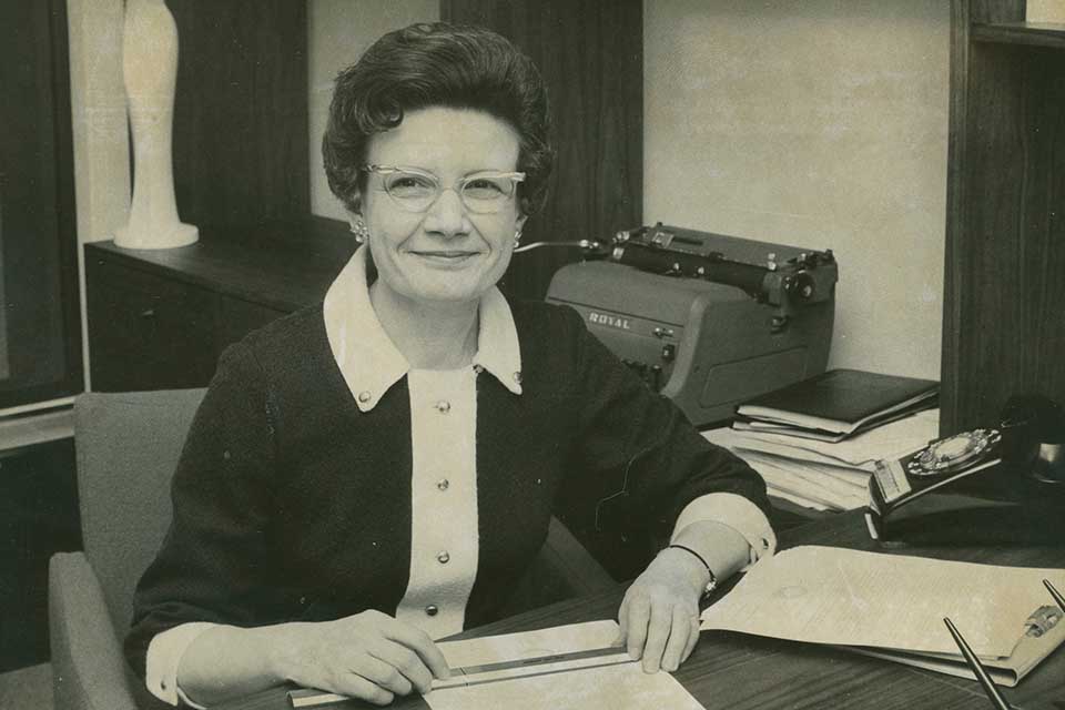 Mary Bruemmer at work A historic picture of Mary Bruemmer sitting at a desk