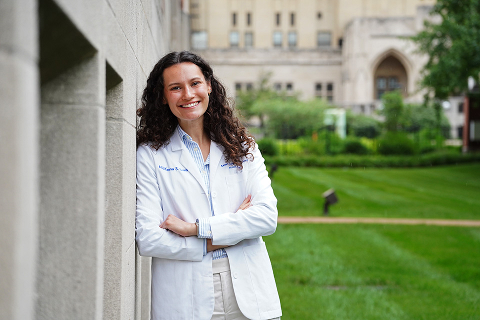 McKenna Smith McKenna Smith poses for a photo outside on campus wearing a white doctor's coat.