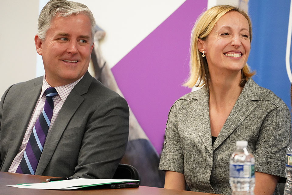 Center for Bosnian Studies A man and woman smile while sitting at a table during an event.