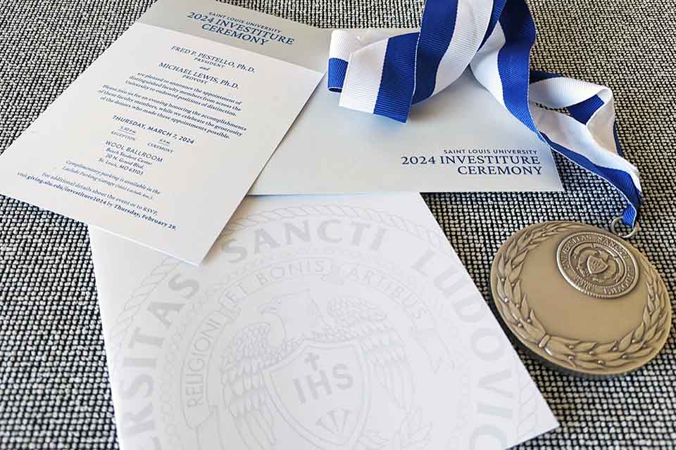 The invitation program and medallions for SLU's 2024 investiture ceremony