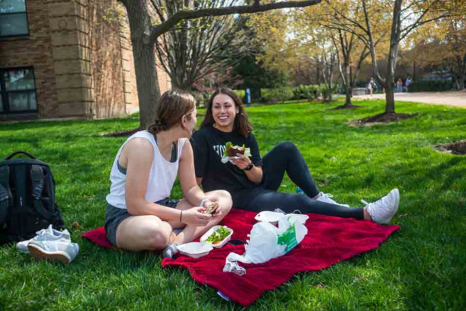 Two students enjoying a picnic