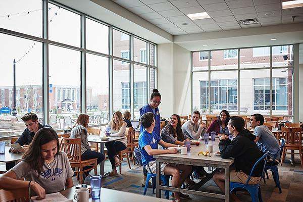 Students eating in Grand Dining Hall during the day