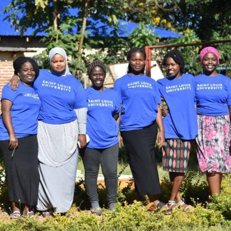 A group of students wearing SLU t-shirts pose for a photo.
