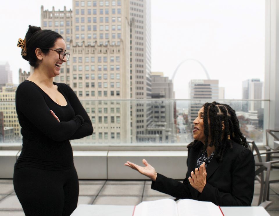 Professor Griggs talks with a student on the patio at Scott Hall Professor Griggs talks with a student on the patio at Scott Hall