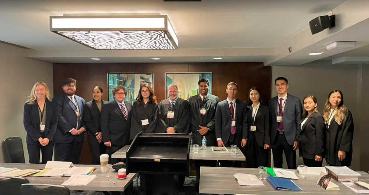 The Jessup team poses with judges as well as their competitors from 