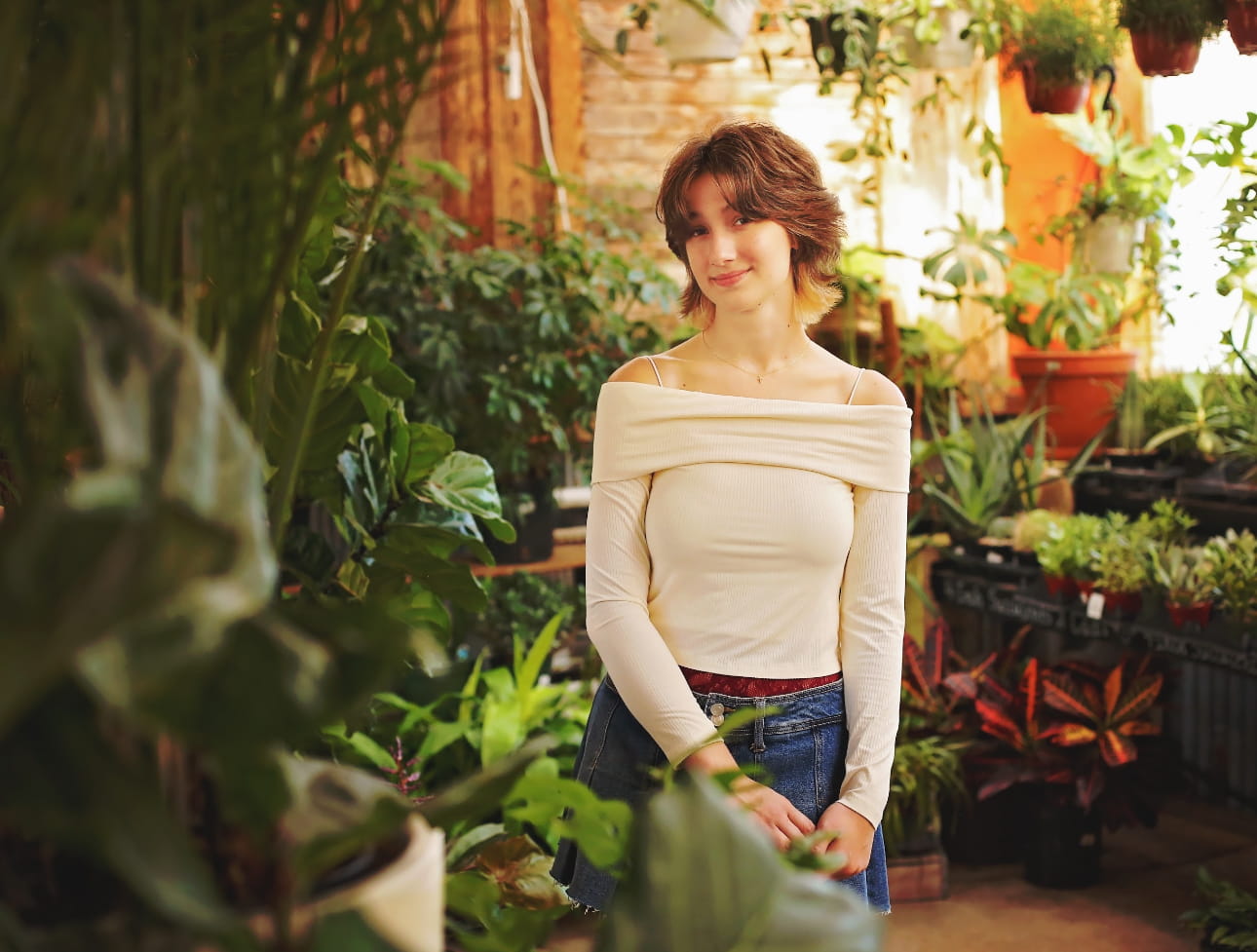 photo of mia standing in a greenhouse