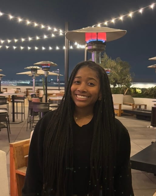 Photo of Naiyah standing on a patio