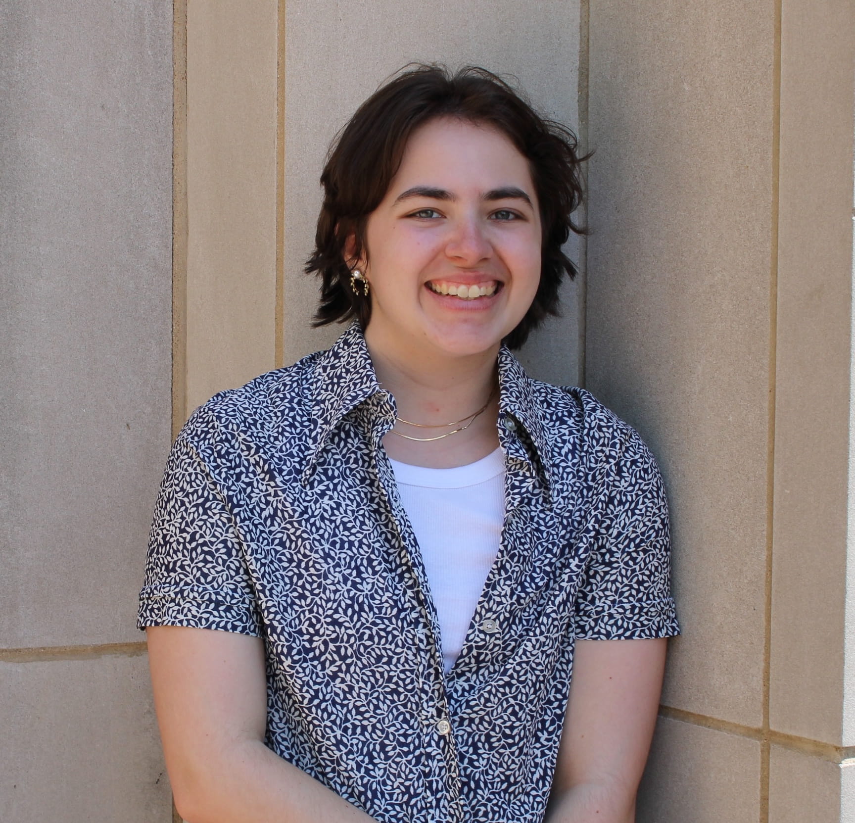 rachel smiling against a wall