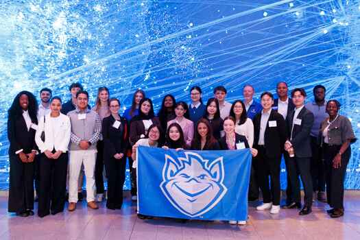 Students standing in front of an interesting background at a career trek. 