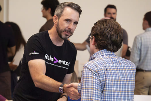 A employer and student shaking hands. 
