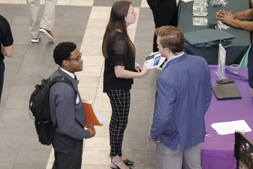Two people talking at a fair
