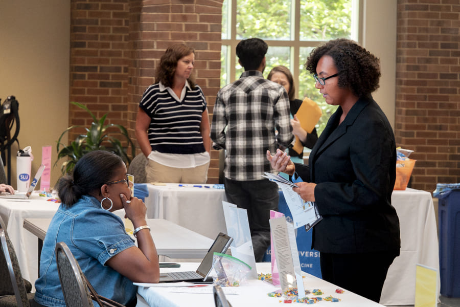 Person talking to an employer at a career fair. 