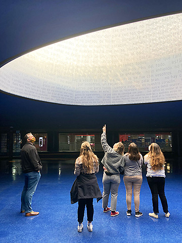 Students examine the Monument to the Victims of 11-M in Atocha Station.