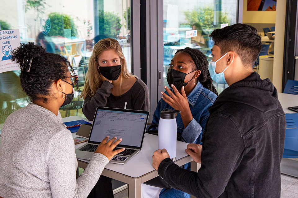 Four students working at a table