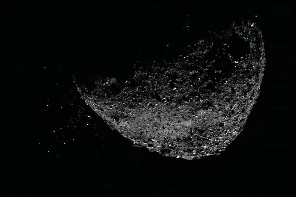 View of asteroid Bennu's surface, a large rocky object suspended in space.