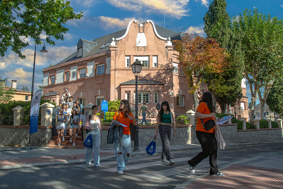 Students crossing street in front of Padre Arrupe Hall.