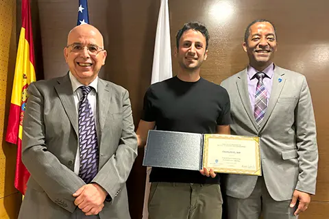 Gregory Triplett, Ph.D., Dean of SLU's School of Science and Engineering, traveled to Madrid to personally congratulate and present the honor to Charles El Mir, Ph.D.