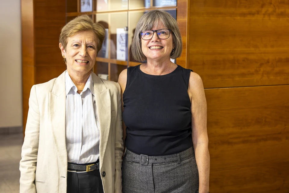 Encinar (left) and McCabe (right) pose for photo during reception in San Ignacio Hall.