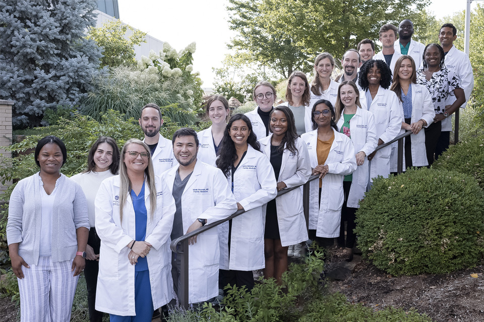Family and Community Medicine Faculty pose for a photo while standing on a staircase outside.