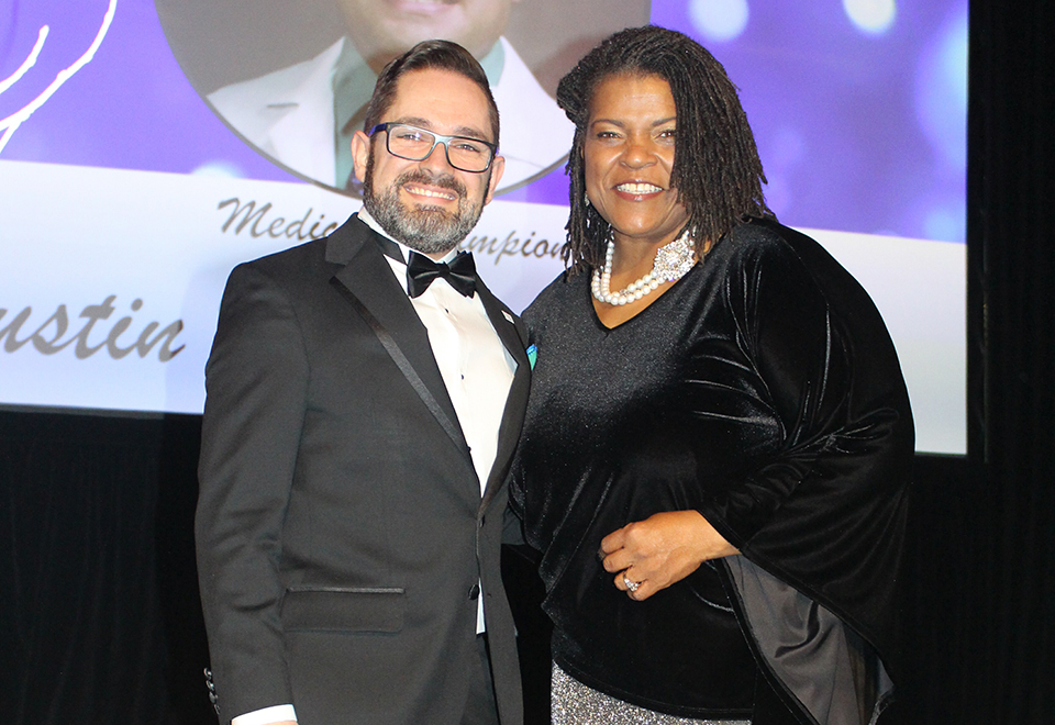 SLUCare pediatric rheumatologist Austin Dalrymple, DO, left, received the St. Louis Chapter of the Arthritis Foundation's medical champion award from KMOX Radio's Carol Daniel, right, on Saturday, Dec. 7. Photo courtesy of the Arthritis Foundation. 