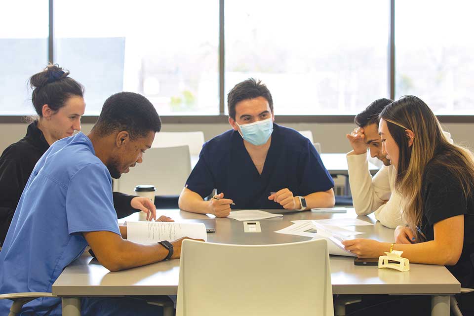 Students sitting around a table in their learning community