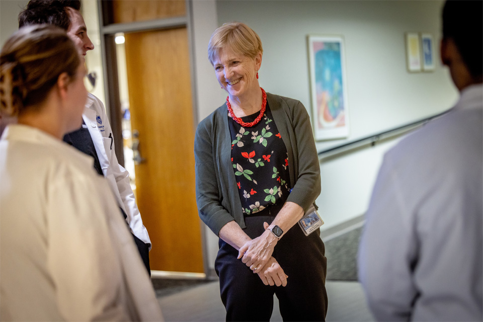 A shot of Dr. Jacobs Speaking to fellow doctors at a coffee with the dean event